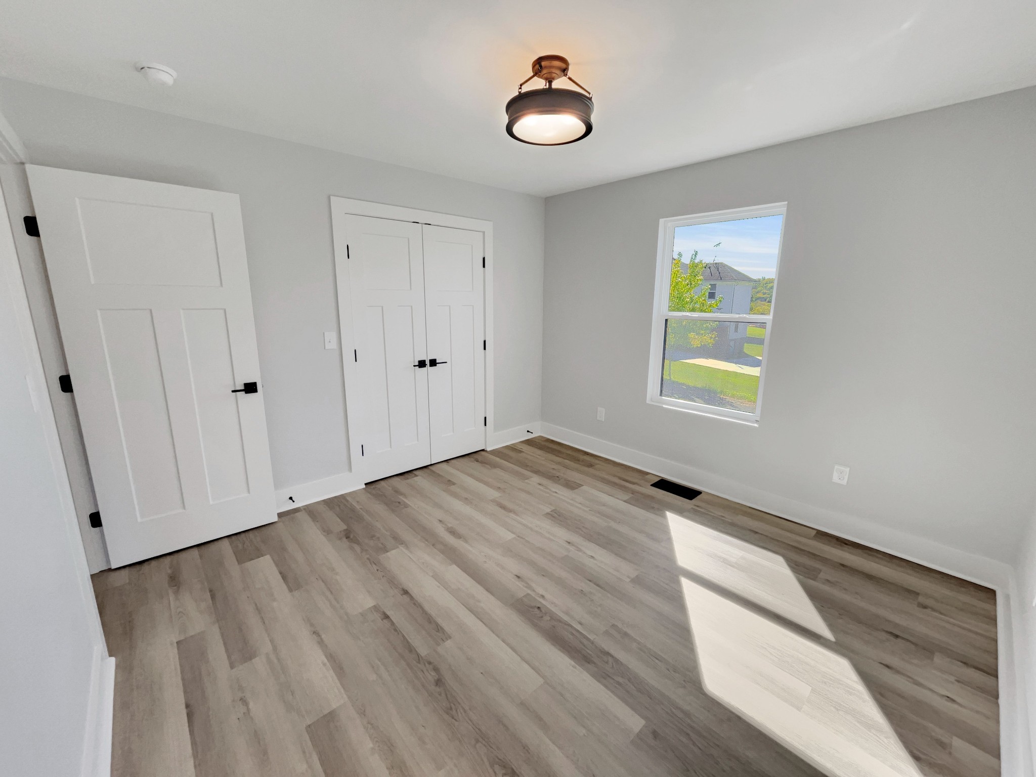 200 New Town Road Watertown, TN 37184 - Photo 8 of 13 a view of an empty room with window and wooden floor