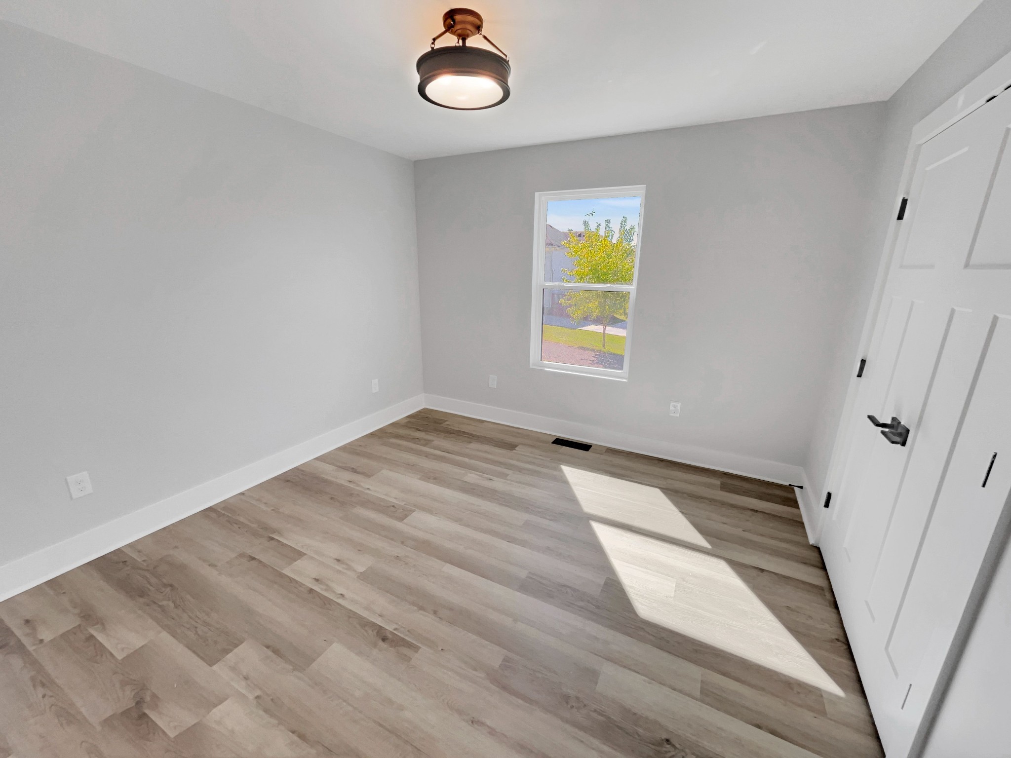 200 New Town Road Watertown, TN 37184 - Photo 9 of 13 a view of empty room with window and wooden floor