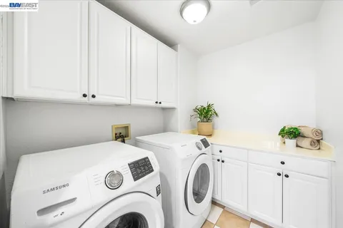 a front view of a house with a yard and potted plants