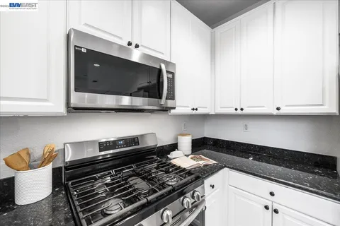 a living room with fireplace furniture and a large window