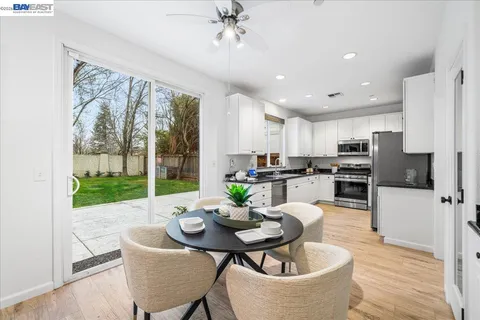 a bedroom with a large bed and a chandelier fan
