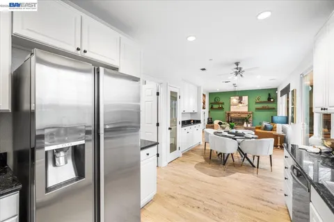 a bathroom with a double vanity sink mirror and next to a window