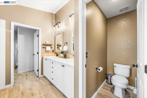 a view of a yard with a house and a large tree