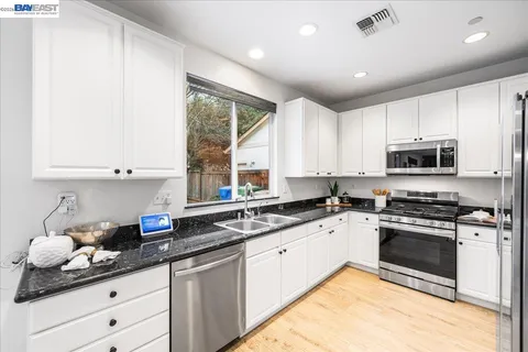 a bedroom with a bed and a flat tv screen on a dresser