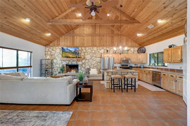 a living room with stainless steel appliances kitchen island granite countertop lots of counter top space
