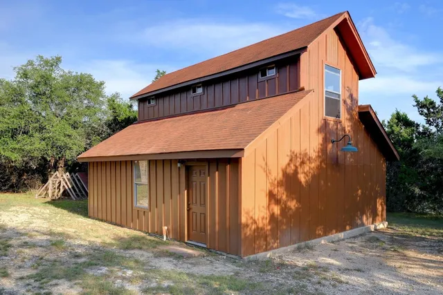 a backyard of a house with table and chairs