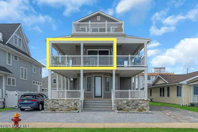 a front view of a residential apartment building with a yard