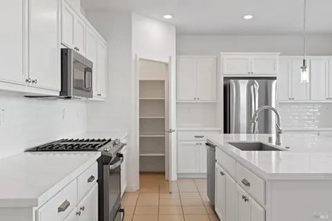a kitchen with stainless steel appliances a sink stove and refrigerator