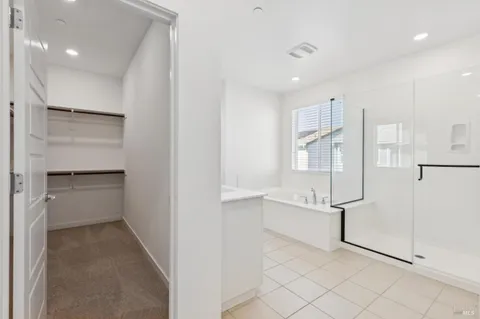 a view of walk in closet with empty shelves