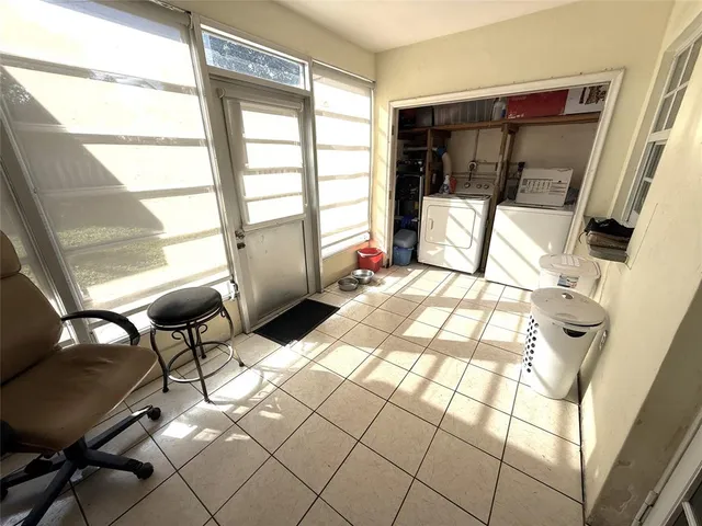 a living room with a large window and furniture