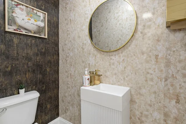 a living room with furniture a bookshelf and a flat screen tv