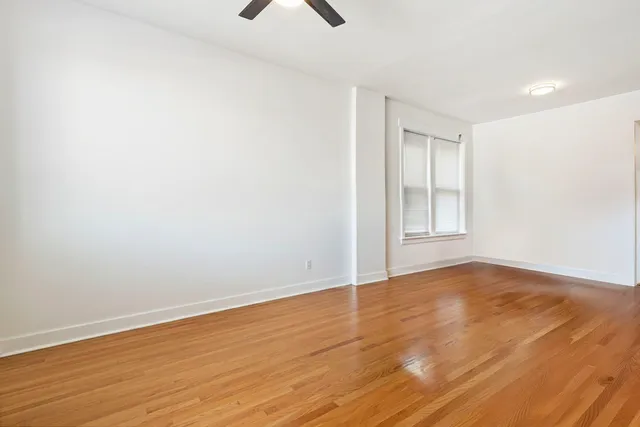 a view of hallway with wooden floor