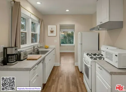 a kitchen with a sink stove and microwave