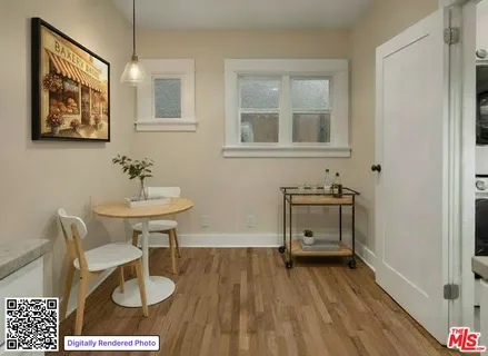 a view of a workspace with furniture and wooden floor