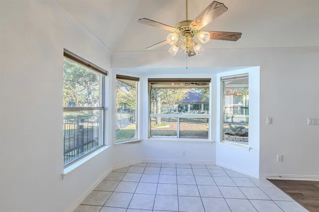 a white kitchen with granite countertop a sink and white cabinets