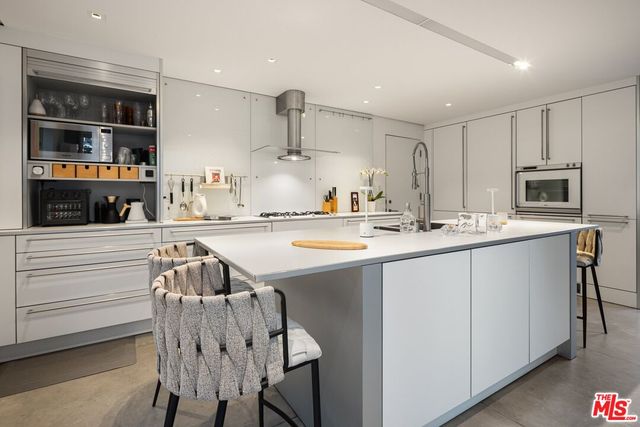 a dining room with furniture and a potted plant