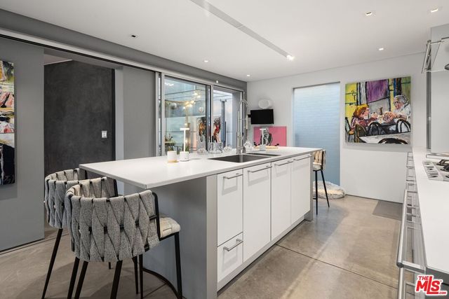 a dining room with furniture and a potted plant