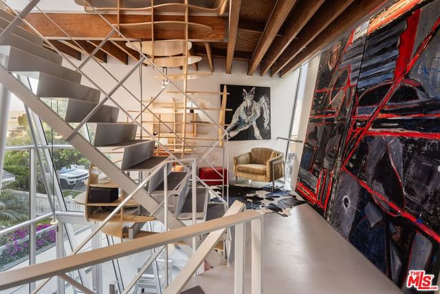 a blue couch sitting in a living room next to a window