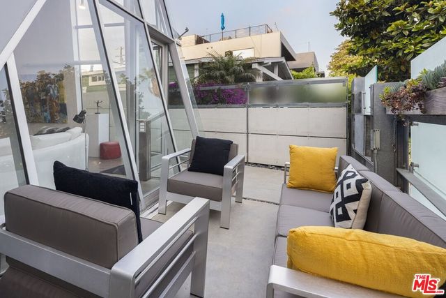 a view of a room with furniture and wooden floor