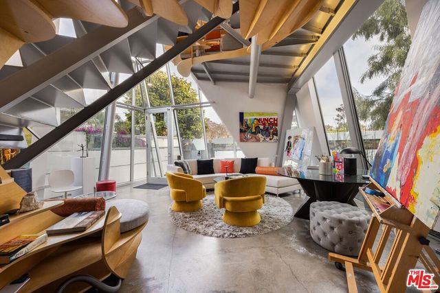 a view of a dining room with furniture and a potted plant