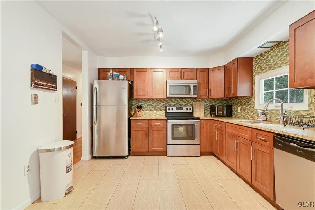 400 Carlton Road Mount Pocono, PA 18344 - Photo 14 of 50 a kitchen with stainless steel appliances granite countertop a refrigerator sink and cabinets