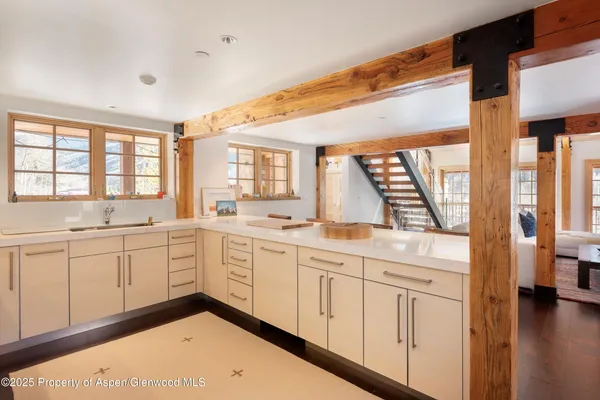 a large white kitchen with a large window