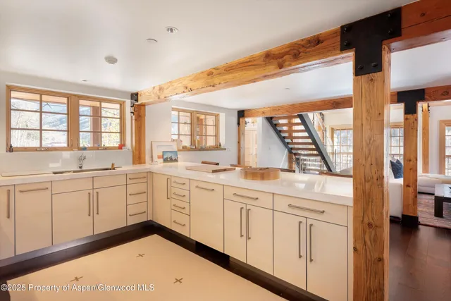 a large white kitchen with a large window