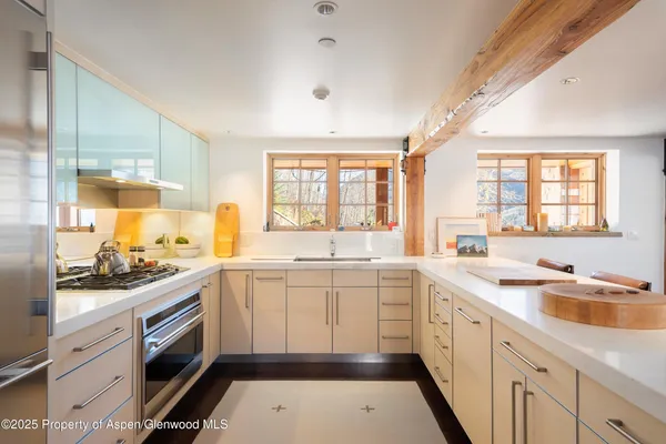 a kitchen with a sink stove and cabinets