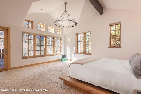 a spacious bedroom with a bed and a window