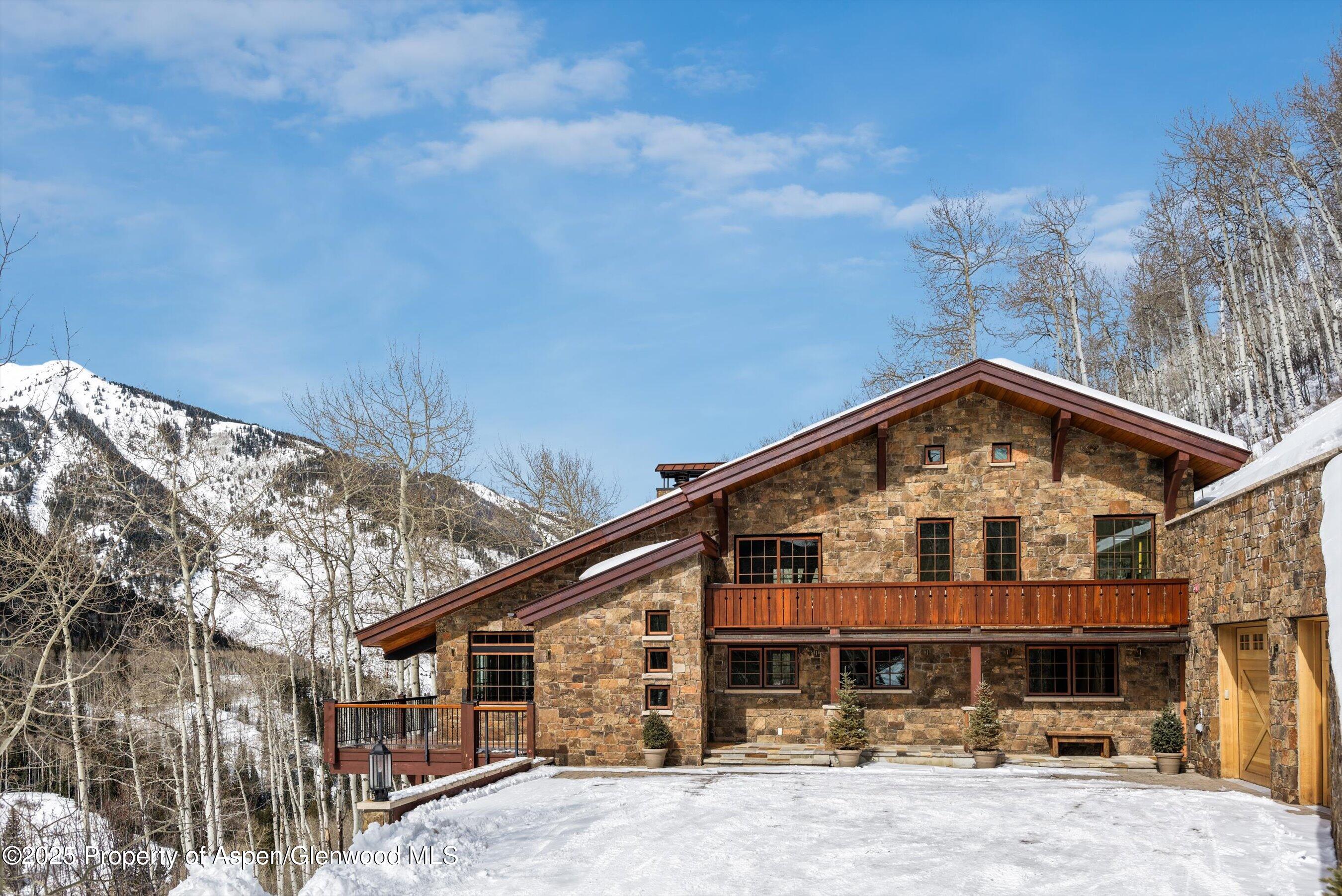 6770 Castle Creek Road Aspen, CO 81612 - Photo 2 of 53 a front view of a house with yard and hallway