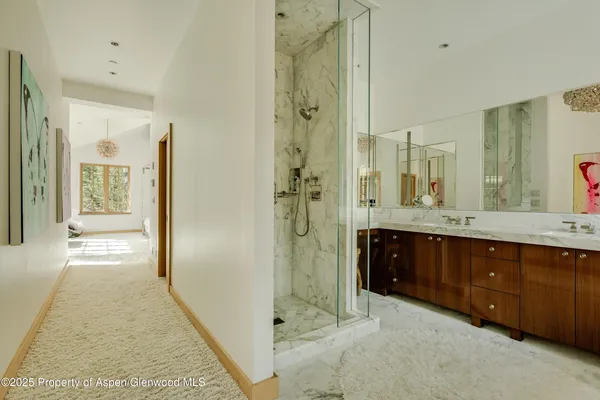 a spacious bathroom with a shower sink and mirror