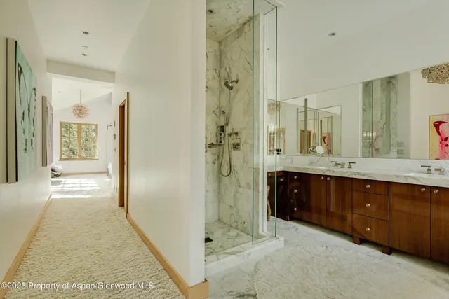 a spacious bathroom with a shower sink and mirror