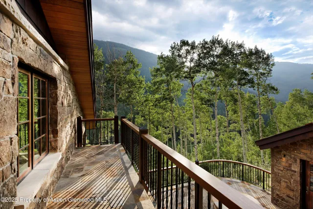 a balcony with table and chairs