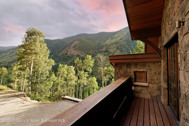 a view of a wooden chairs on the roof deck