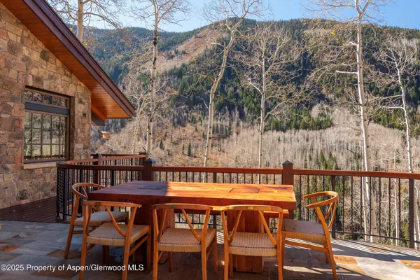 a backyard of a house with barbeque oven table and chairs