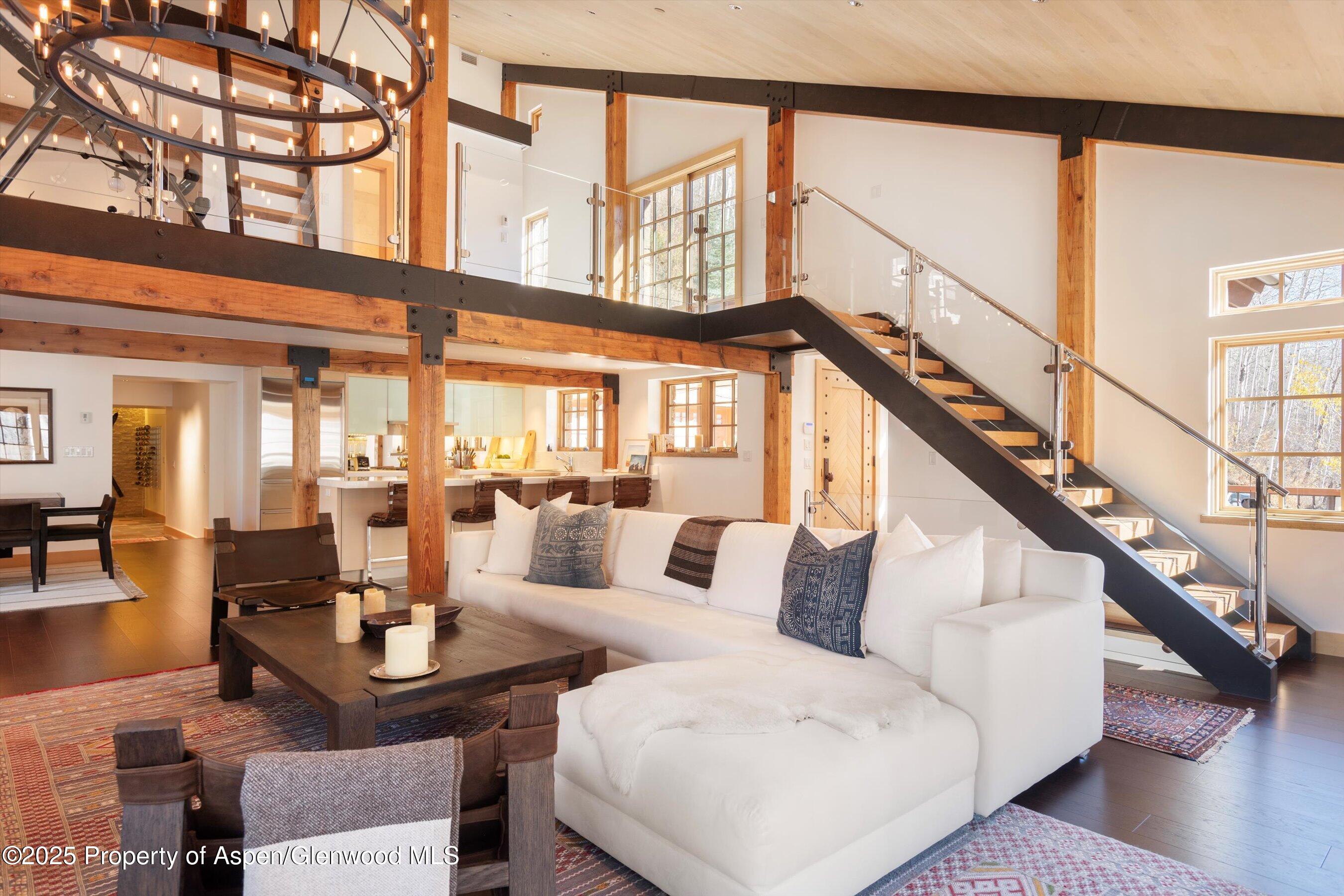 6770 Castle Creek Road Aspen, CO 81612 - Photo 6 of 53 a living room with furniture and floor to ceiling windows and wooden floor