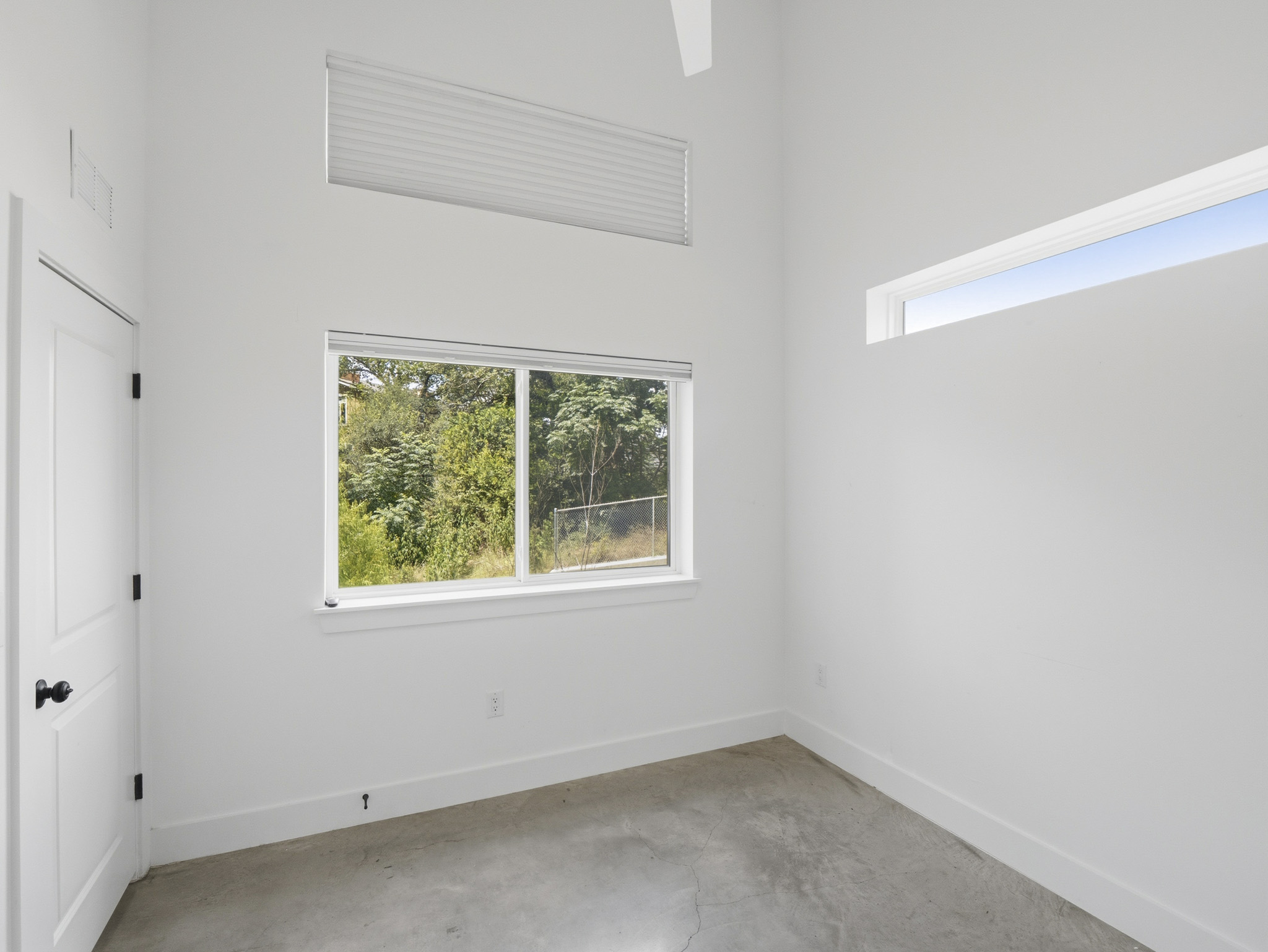 5005 Lott Avenue, Unit 2 Austin, TX 78721 - Photo 23 of 25 Natural illumination fills this room, showcasing tall ceilings and expansive outdoor views.