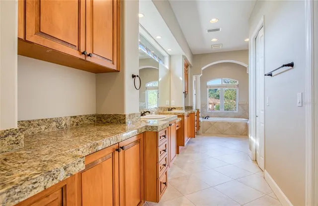 a view of swimming pool with outdoor seating and plants
