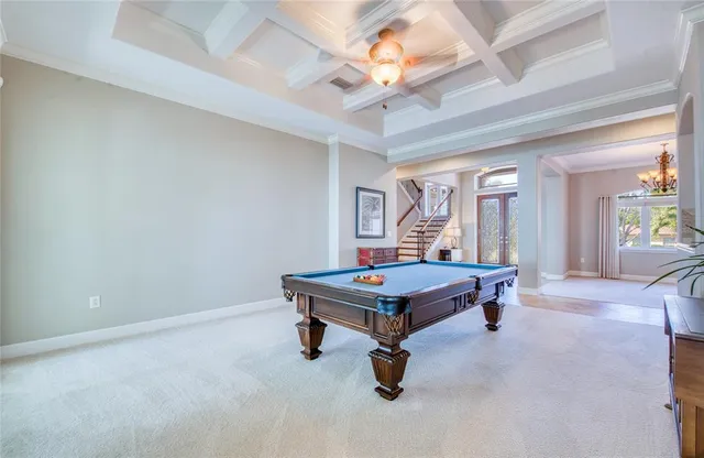 a large kitchen with kitchen island granite countertop wooden cabinets and stainless steel appliances