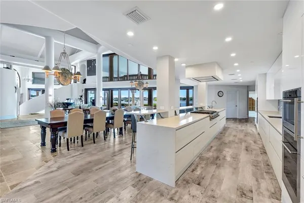 a large white kitchen with lots of furniture and counter space