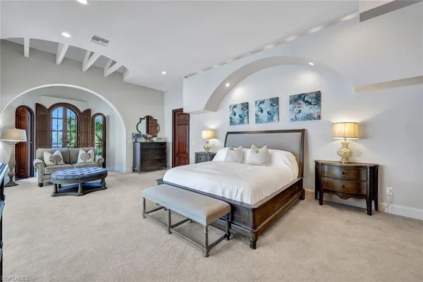 a spacious bedroom with a bed and a table