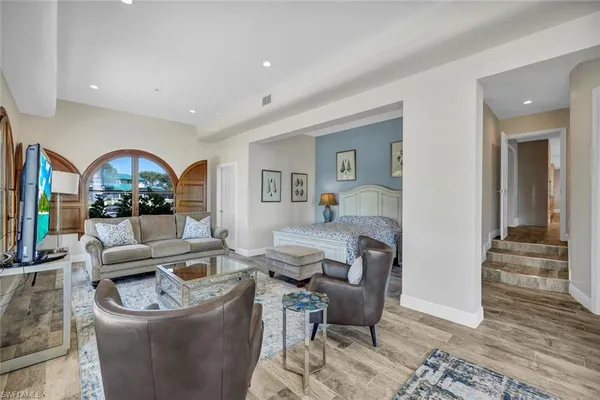 a living room with furniture and a wooden floor