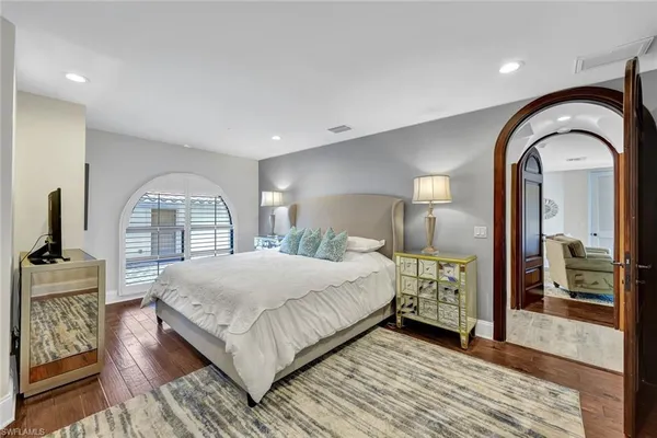 a bedroom with a large bed and a window