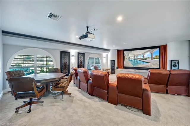a living room with furniture a large window and a flat screen tv