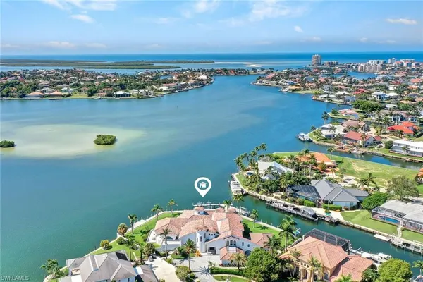 an aerial view of a houses with a lake view