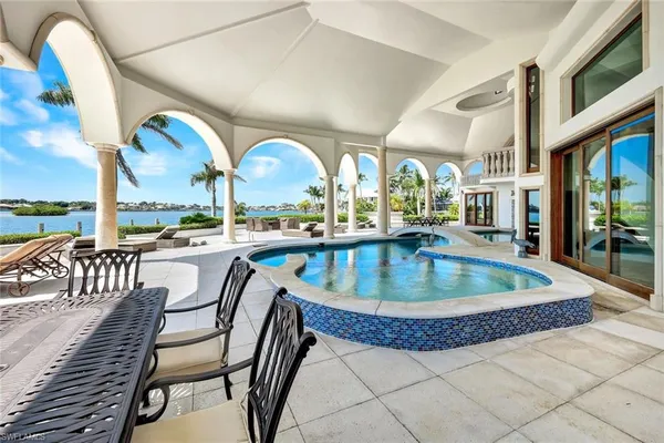 a view of a swimming pool with outdoor seating