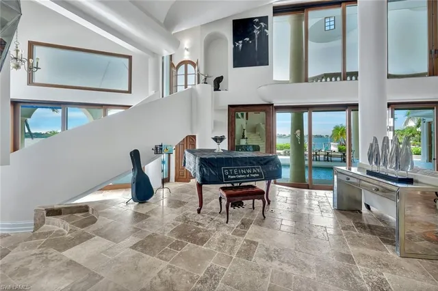 a dining room with furniture and a floor to ceiling window