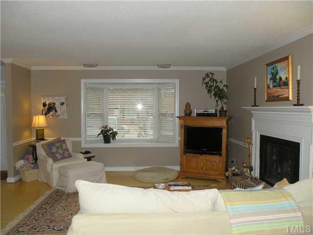 1346 Baez Street Raleigh, NC 27608 - Photo 4 of 12 a living room with furniture and a fireplace
