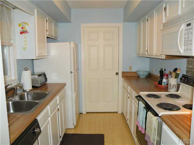 1346 Baez Street Raleigh, NC 27608 - Photo 6 of 12 a kitchen with stainless steel appliances granite countertop a sink stove and refrigerator