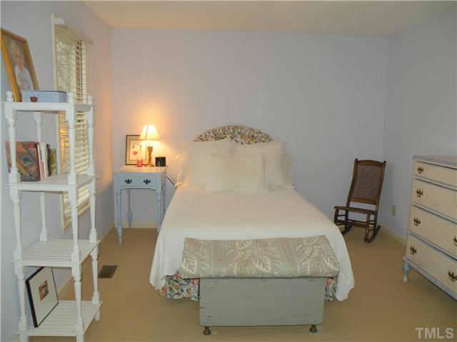 1346 Baez Street Raleigh, NC 27608 - Photo 9 of 12 a bedroom with a bed and a cabinets